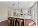 Bright kitchen features a central island with seating, marble backsplash, and stainless appliances at 2242 Terrabrook Ln, Charleston, SC 29412