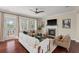 Cozy living room with a fireplace, modern ceiling fan, and large windows offering ample natural light at 2242 Terrabrook Ln, Charleston, SC 29412