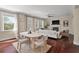 Open-concept living room with a fireplace, seamlessly connecting to the dining area with lots of natural light at 2242 Terrabrook Ln, Charleston, SC 29412