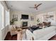 Comfortable living room with a fireplace and a ceiling fan, open to the dining area at 2242 Terrabrook Ln, Charleston, SC 29412