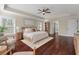 Well-lit primary bedroom featuring a plush bed, hardwood floors, and ample closet space at 2242 Terrabrook Ln, Charleston, SC 29412