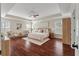 Bright primary bedroom featuring tray ceilings, hardwood floors, and neutral decor at 2242 Terrabrook Ln, Charleston, SC 29412
