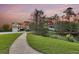Picturesque neighborhood view featuring well-maintained homes, lush landscaping, and tranquil pond at 2242 Terrabrook Ln, Charleston, SC 29412