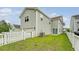 Beautiful backyard shows lush lawn, white picket fence, and gray siding on the house at 227 Oak View Way, Summerville, SC 29483