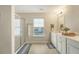 Bright bathroom with double vanity, glass shower, and large window with neighborhood views at 227 Oak View Way, Summerville, SC 29483