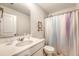 A simple bathroom with single sink vanity and shower featuring a colorful curtain at 227 Oak View Way, Summerville, SC 29483