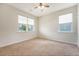 This carpeted bedroom features two windows providing natural light and a ceiling fan at 227 Oak View Way, Summerville, SC 29483