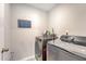 Well-lit laundry room features modern washer and dryer set with a decorative 'Love and Laundry' wall sign at 227 Oak View Way, Summerville, SC 29483
