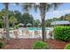 Resort-style pool area with lounge chairs, cabanas, and lush tropical landscaping for a relaxing experience at 227 Oak View Way, Summerville, SC 29483
