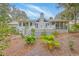 Charming backyard with a white painted deck, lush greenery, and a well-maintained lawn at 26 Edgewater Aly, Isle of Palms, SC 29451