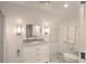 Bright, well lit bathroom featuring a marble vanity, mirror, and a toilet with white walls at 26 Edgewater Aly, Isle of Palms, SC 29451