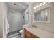 Modern bathroom with stand-up shower, glass door and wooden vanity with a marble countertop at 26 Edgewater Aly, Isle of Palms, SC 29451