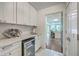 Convenient butler's pantry with wine fridge, sink, and ample cabinet space, connecting to the main kitchen area at 26 Edgewater Aly, Isle of Palms, SC 29451