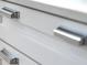 Close-up of white cabinetry featuring sleek, modern hardware, highlighting the quality of the kitchen's design at 26 Edgewater Aly, Isle of Palms, SC 29451