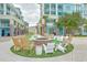 Cozy fire pit surrounded by chairs on artificial turf, perfect for outdoor gatherings and relaxation at 26 Edgewater Aly, Isle of Palms, SC 29451