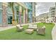Inviting outdoor lounge area with comfortable seating on artificial turf in a colorful resort setting at 26 Edgewater Aly, Isle of Palms, SC 29451