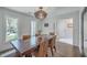 Well-lit dining room with a dark wood table, wicker chairs, and access to other rooms at 26 Edgewater Aly, Isle of Palms, SC 29451