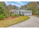 Inviting home featuring manicured lawn, mature landscaping, and a two-car garage, creating a welcoming curb appeal at 26 Edgewater Aly, Isle of Palms, SC 29451