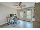 Home office featuring hardwood floors, a ceiling fan, a work desk and built-in shelves at 26 Edgewater Aly, Isle of Palms, SC 29451