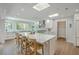Bright kitchen features a large island with seating, stainless steel appliances, and plenty of natural light from skylights at 26 Edgewater Aly, Isle of Palms, SC 29451