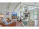 Bright living room with vaulted ceilings, exposed beams, fireplace, ceiling fan, and comfortable seating arrangement at 26 Edgewater Aly, Isle of Palms, SC 29451