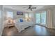 Bright main bedroom featuring hardwood floors, a ceiling fan, and a sliding glass door to the porch at 26 Edgewater Aly, Isle of Palms, SC 29451