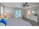 Bright bedroom featuring hardwood floors, a ceiling fan, and a sliding glass door to the porch at 26 Edgewater Aly, Isle of Palms, SC 29451