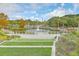 Scenic view of a pond and water fountain, surrounded by lush landscaping and walking paths at 26 Edgewater Aly, Isle of Palms, SC 29451