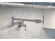 Close-up of a sleek, chrome pot filler faucet against a stylish mosaic tile backsplash at 26 Edgewater Aly, Isle of Palms, SC 29451