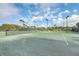View of a well-maintained green tennis court with net, lights, and a covered picnic pavilion at 26 Edgewater Aly, Isle of Palms, SC 29451
