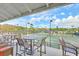 View of well-maintained tennis courts from shaded outdoor seating area on deck with tables and chairs at 26 Edgewater Aly, Isle of Palms, SC 29451