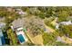 Aerial view of a home with backyard pool surrounded by trees and neighborhood at 2629 Goldbug Ave, Sullivans Island, SC 29482