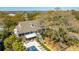 Aerial view of a sprawling property with a pool, lush greenery, and a charming residence at 2629 Goldbug Ave, Sullivans Island, SC 29482