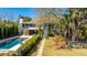 Stunning home exterior with a pool, lush landscaping, and a charming pathway leading to the house at 2629 Goldbug Ave, Sullivans Island, SC 29482