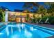 Inviting backyard pool with waterfall feature and lounge chairs, perfect for relaxation and outdoor entertaining at 2629 Goldbug Ave, Sullivans Island, SC 29482