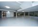 Spacious basement area with concrete pillars, white walls, and access to the backyard at 2629 Goldbug Ave, Sullivans Island, SC 29482