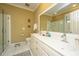 Bathroom with double sink vanity, tiled floors, and a glass-enclosed shower at 2629 Goldbug Ave, Sullivans Island, SC 29482