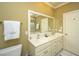 Bright bathroom with a double vanity, towel, and a toilet next to a full-length mirror at 2629 Goldbug Ave, Sullivans Island, SC 29482