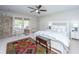 Bright bedroom with ceiling fan, ornamental furnishings, and private access to an outdoor patio at 2629 Goldbug Ave, Sullivans Island, SC 29482