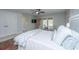 Comfortable bedroom with ceiling fan, ornamental furnishings, and private access to an outdoor patio at 2629 Goldbug Ave, Sullivans Island, SC 29482