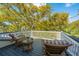 Inviting deck area with wicker furniture perfect for enjoying the lush backyard views at 2629 Goldbug Ave, Sullivans Island, SC 29482