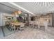 Charming dining area with a wooden table, pendant lights, and access to an outdoor kitchen and seating area at 2629 Goldbug Ave, Sullivans Island, SC 29482