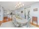 Bright dining room with a stylish chandelier and access to the kitchen and patio at 2629 Goldbug Ave, Sullivans Island, SC 29482