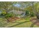 Beautiful home exterior with a spacious porch, well-manicured lawn, and lush landscaping at 2629 Goldbug Ave, Sullivans Island, SC 29482