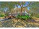 Charming two-story home with a large, covered porch and well-maintained landscaping and unique vehicle at 2629 Goldbug Ave, Sullivans Island, SC 29482