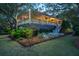 Charming home exterior with inviting porch and lush landscaping, offering a serene and picturesque setting at 2629 Goldbug Ave, Sullivans Island, SC 29482