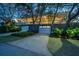 Home featuring a charming exterior with a spacious driveway and well-maintained landscaping, nestled among mature trees at 2629 Goldbug Ave, Sullivans Island, SC 29482