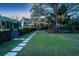 Charming home exterior with landscaped front yard and welcoming entry, lit by outdoor lighting at 2629 Goldbug Ave, Sullivans Island, SC 29482