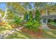 Charming home featuring a welcoming porch, beautiful landscaping, and a stone walkway leading to the entrance at 2629 Goldbug Ave, Sullivans Island, SC 29482