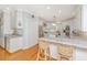 Bright, eat-in kitchen features white cabinets, stainless steel appliances, and marble countertops at 2629 Goldbug Ave, Sullivans Island, SC 29482